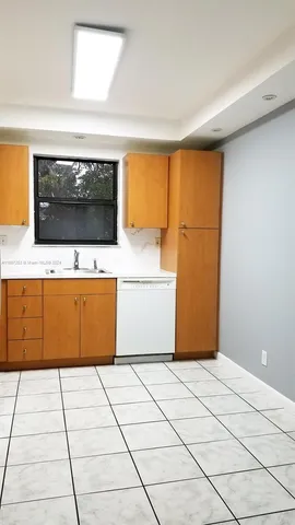 a kitchen with a cabinets and a counter top space