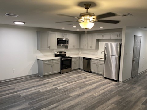 8105 Corinth Street, Unit B Houston, TX 77051 - Photo 23 of 26 a kitchen with stainless steel appliances granite countertop a sink refrigerator stove and microwave