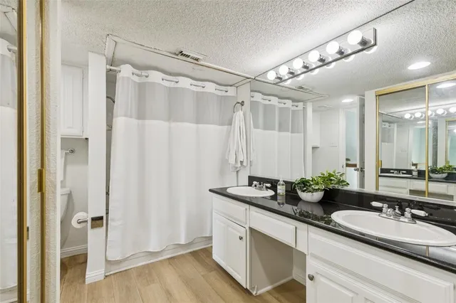 a bathroom with a double vanity sink and mirror