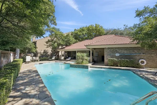 swimming pool view with a seating space