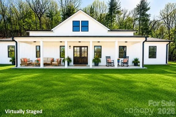a view of a back yard of the house with green space