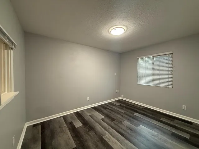 a view of a livingroom with a hall and wooden floor