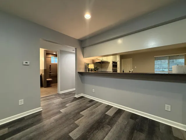 a view of an empty room and wooden floor