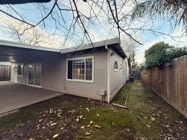 a front view of house with yard and trees