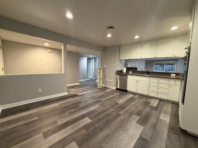 a large kitchen with kitchen island a sink stainless steel appliances and cabinets