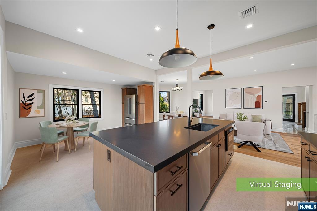 a open kitchen with stainless steel appliances granite countertop a stove and a sink