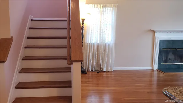 a view of entryway with wooden floor and staircase
