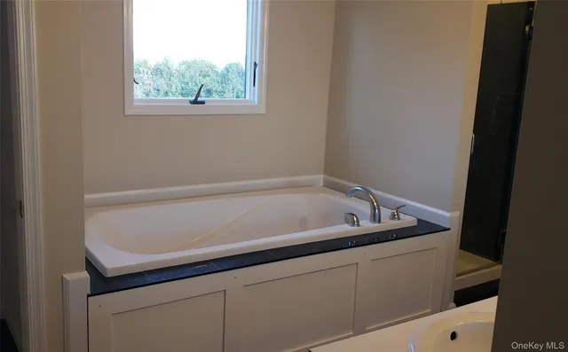 a bath tub sitting next to a window