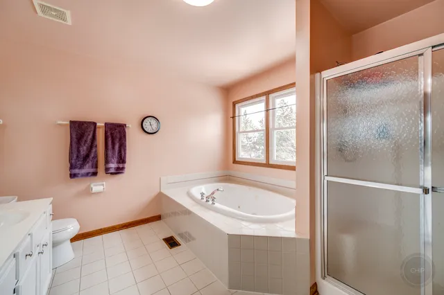a bathroom with a tub sink and mirror