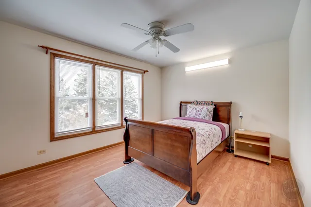 a spacious bedroom with a bed and a large window