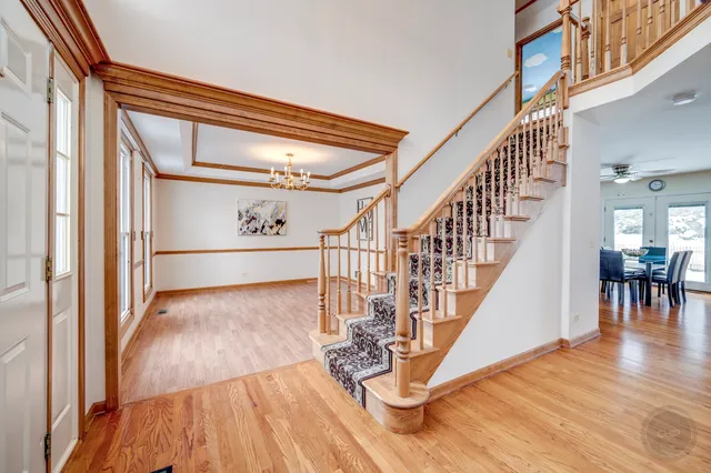 a view of entryway and hall with wooden floor