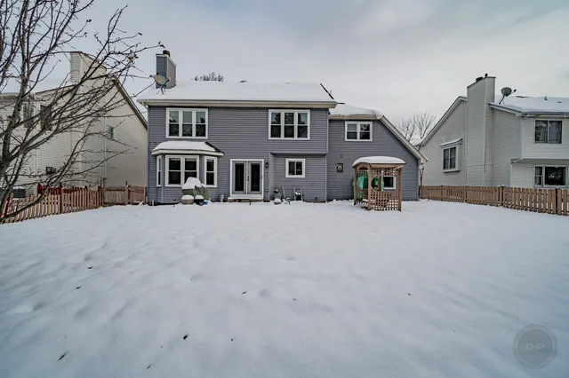a front view of a building with large trees
