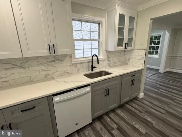 a kitchen with sink and cabinets