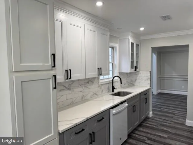 a kitchen with a sink and cabinets