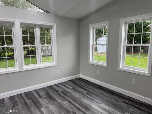 a view of a room with wooden floor and windows