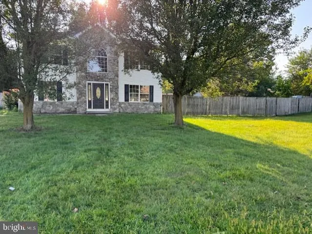 a view of a house with swimming pool and a yard