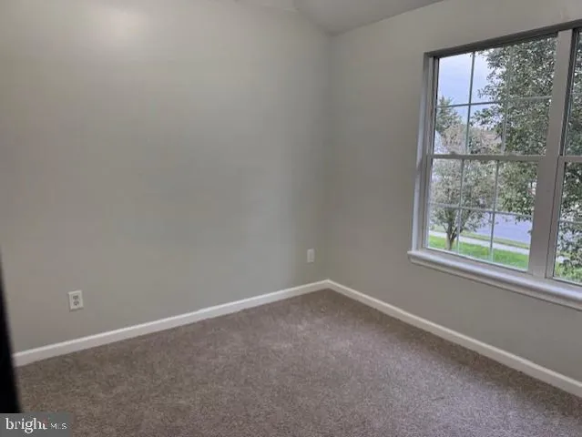 a view of house with backyard