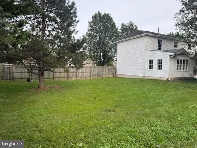 a white house that has a tree in front of the house