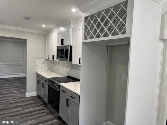 a kitchen with granite countertop a sink and a stove top oven