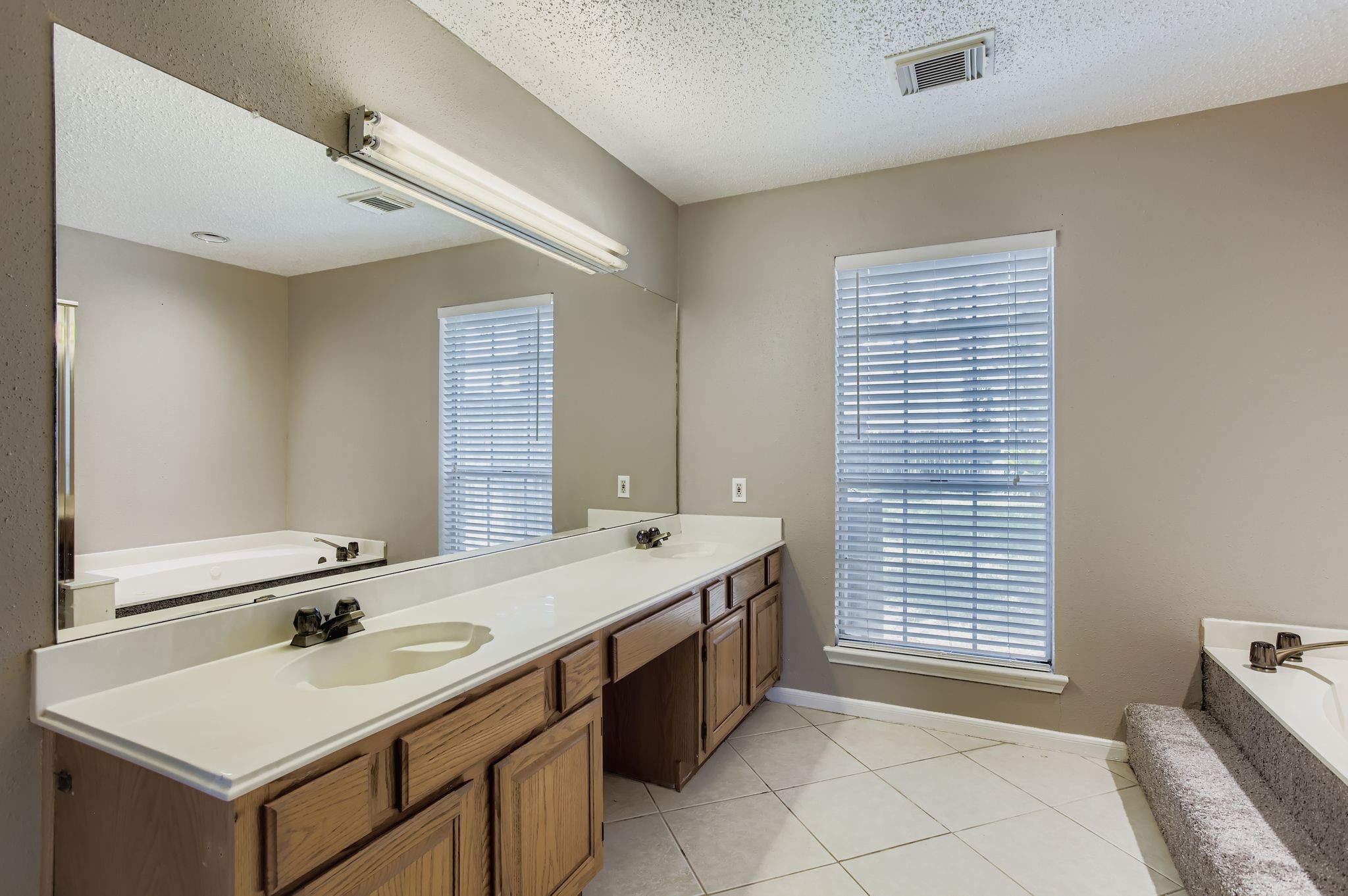 7519 Sunlight Lane Houston, TX 77095 - Photo 17 of 27 a bathroom with a sink and a mirror