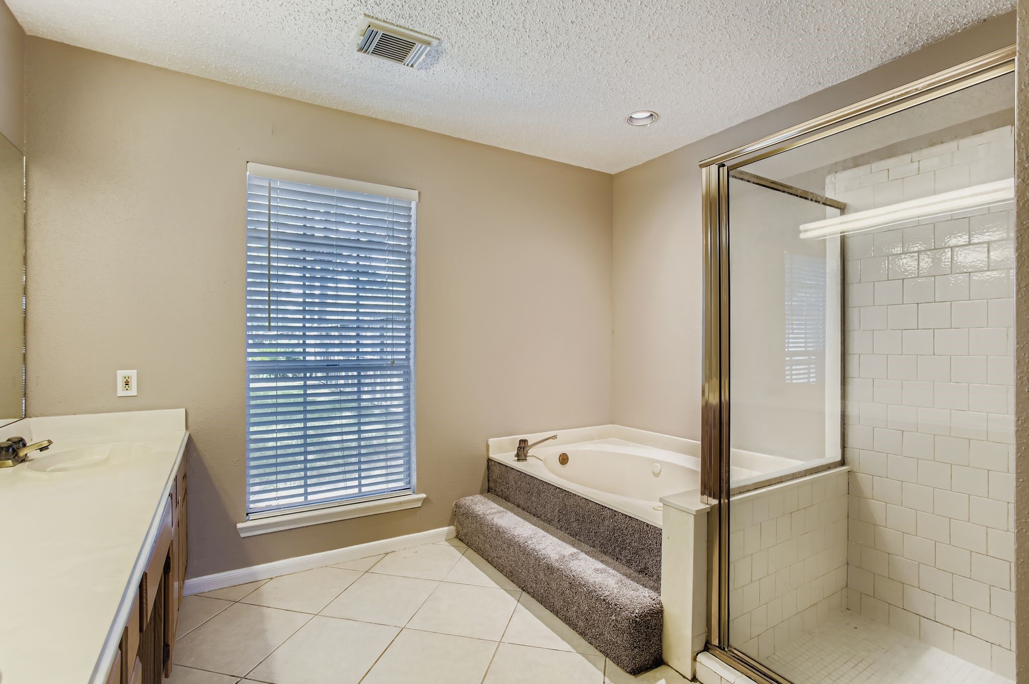 7519 Sunlight Lane Houston, TX 77095 - Photo 18 of 27 a bathroom with a tub and a shower