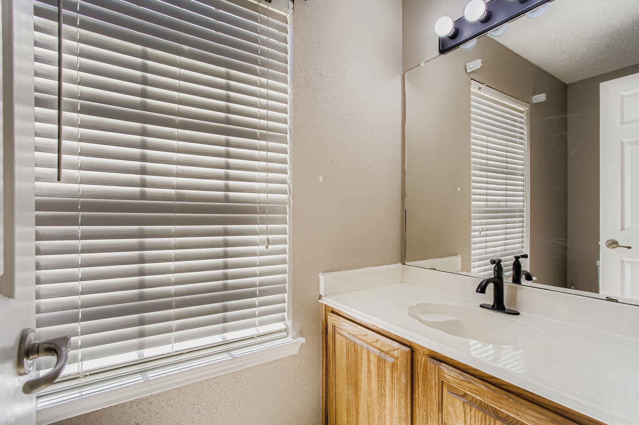 7519 Sunlight Lane Houston, TX 77095 - Photo 19 of 27 a bathroom with a granite countertop sink and a window