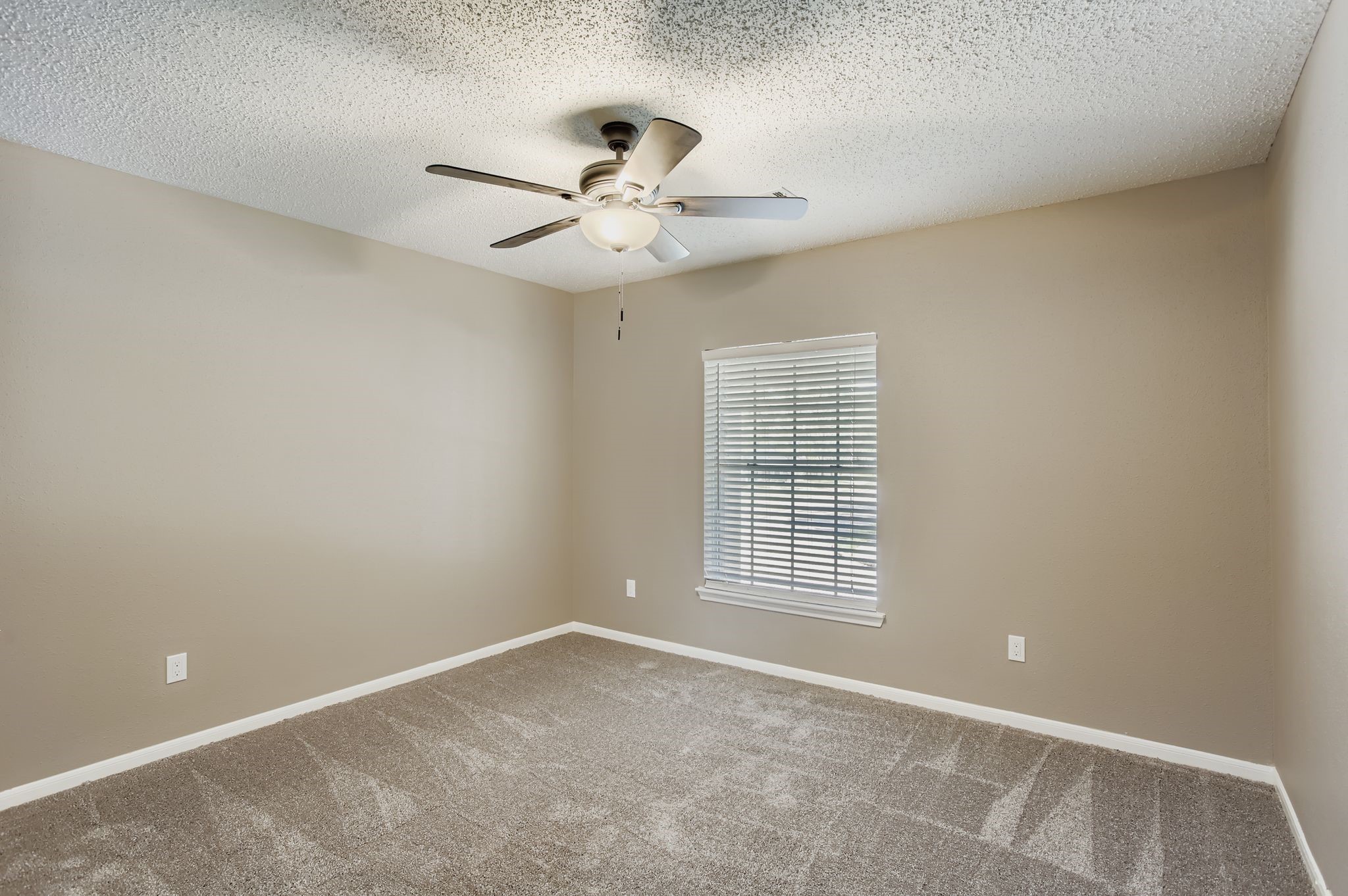 7519 Sunlight Lane Houston, TX 77095 - Photo 23 of 27 an empty room with windows and fan