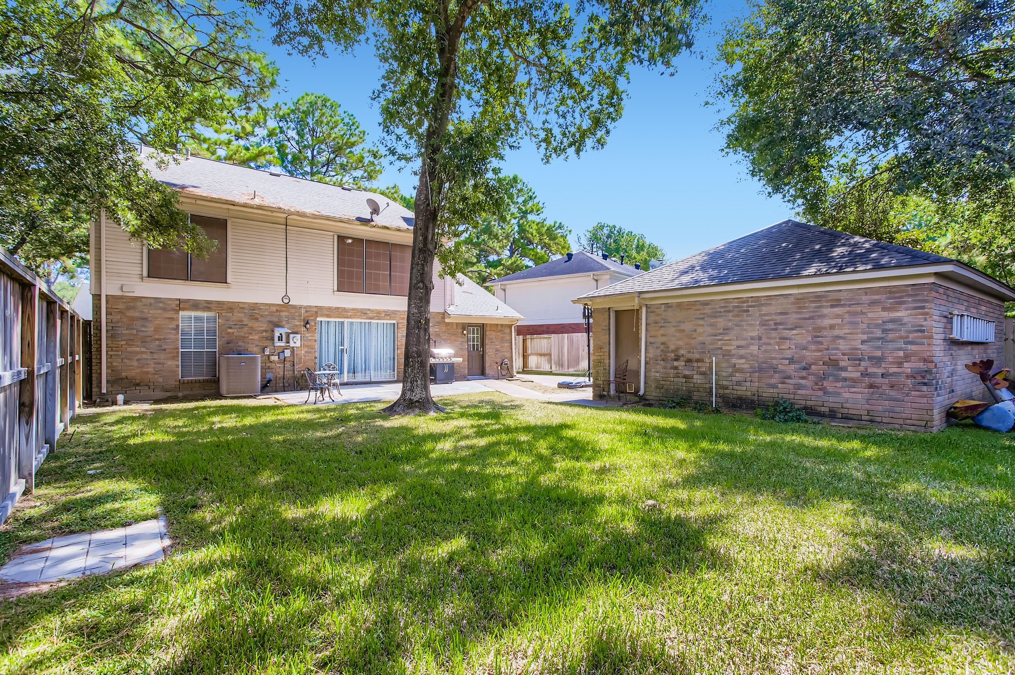 7519 Sunlight Lane Houston, TX 77095 - Photo 25 of 27 a view of a house with a yard and a large tree