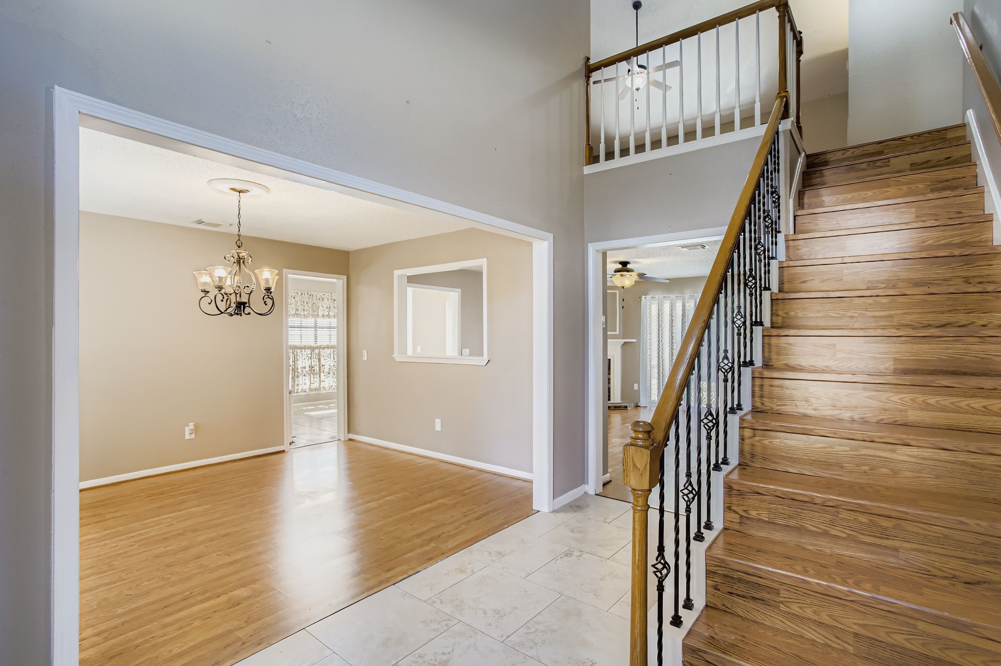 7519 Sunlight Lane Houston, TX 77095 - Photo 5 of 27 a view of a hallway with wooden floor and staircase