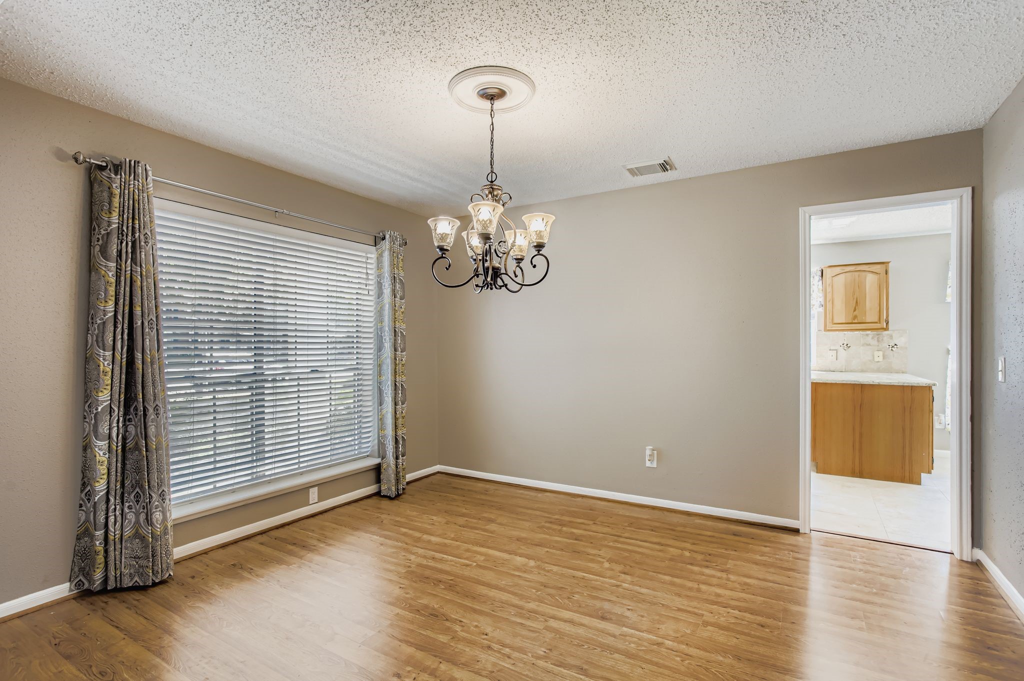 7519 Sunlight Lane Houston, TX 77095 - Photo 9 of 27 wooden floor in an empty room with a window