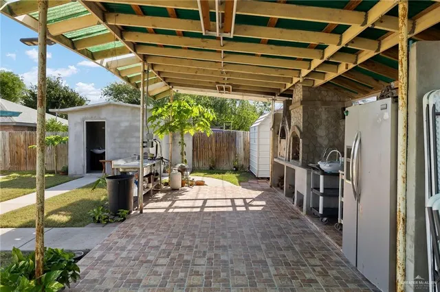 a view of a patio with table and chairs with wooden floor and plants