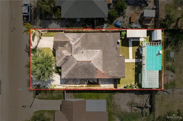 an aerial view of residential houses with outdoor space and swimming pool