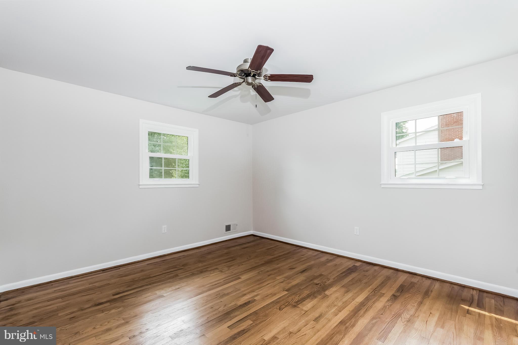 14517 Cobblestone Drive Silver Spring, MD 20905 - Photo 16 of 30 a view of empty room with wooden floor and fan