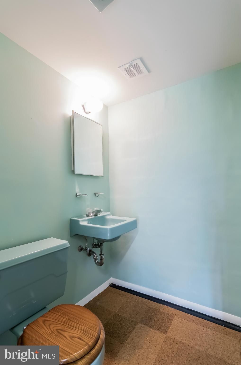 14517 Cobblestone Drive Silver Spring, MD 20905 - Photo 23 of 30 a bathroom with a sink toilet and mirror