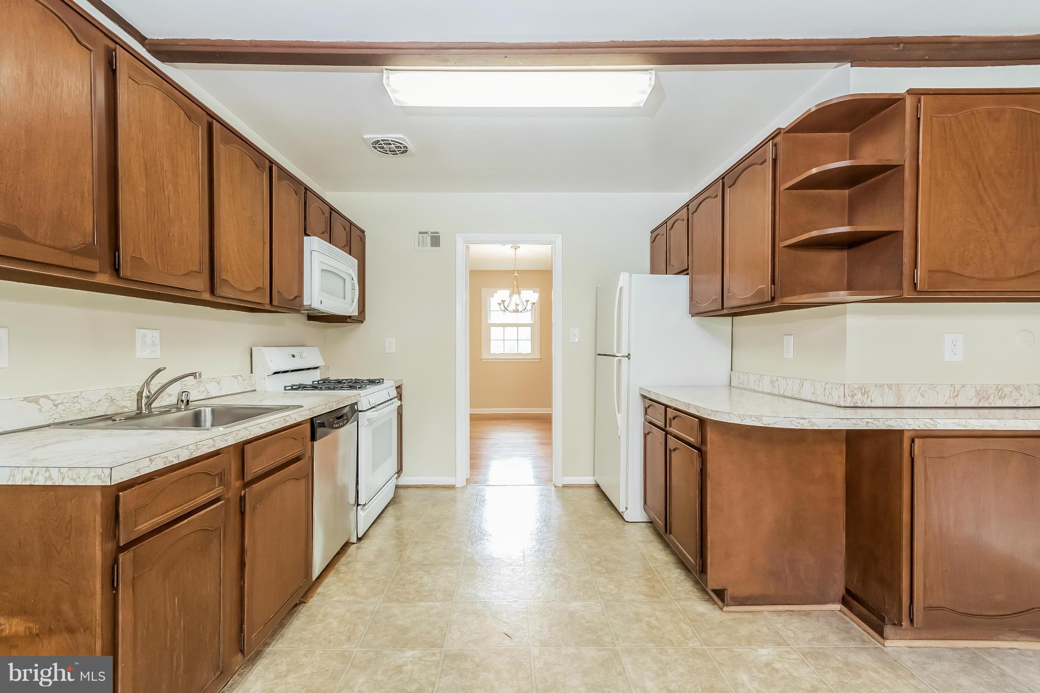 14517 Cobblestone Drive Silver Spring, MD 20905 - Photo 7 of 30 a kitchen with stainless steel appliances granite countertop a sink and cabinets