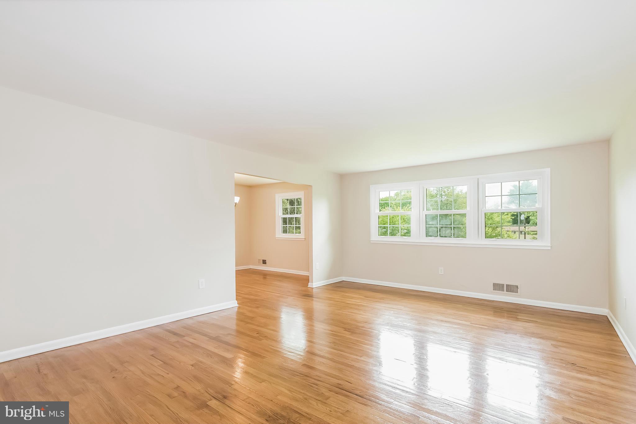 14517 Cobblestone Drive Silver Spring, MD 20905 - Photo 9 of 30 an empty room with wooden floor and windows