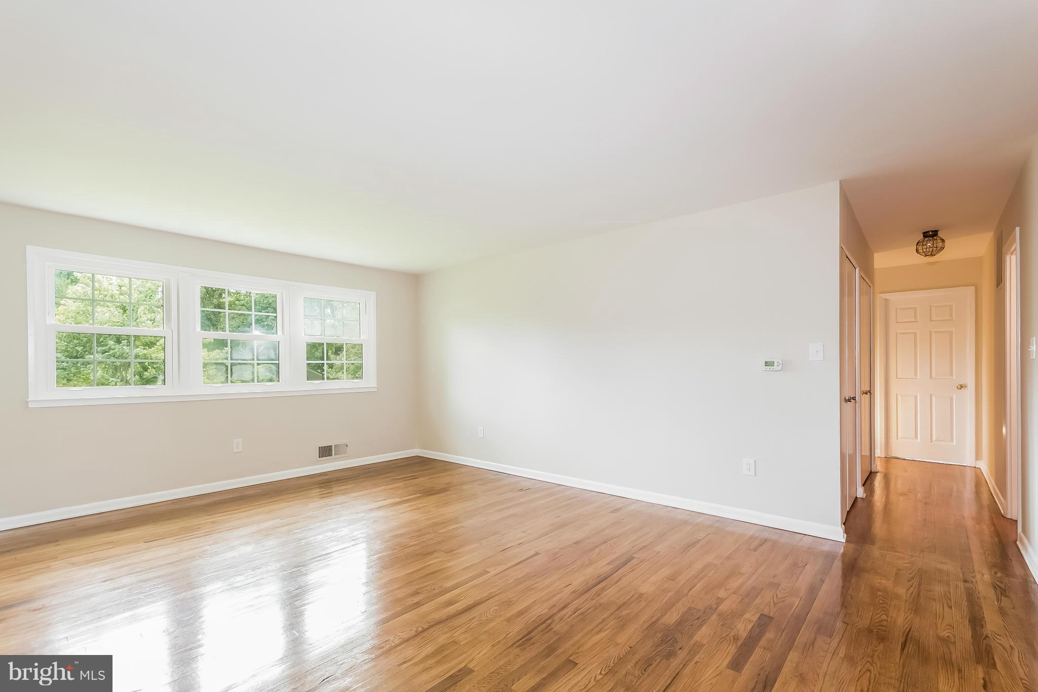 14517 Cobblestone Drive Silver Spring, MD 20905 - Photo 10 of 30 an empty room with wooden floor and windows