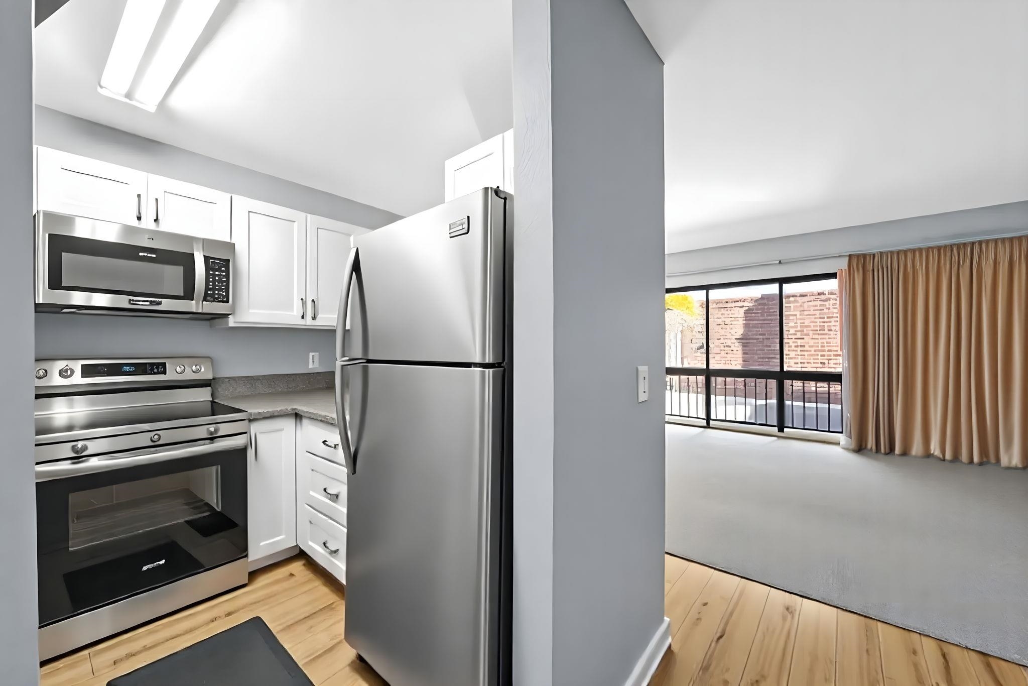 3740 Lower Honoapiilani Road, Unit F106 Lahaina, HI 96761 - Photo 1 of 28 a kitchen with stainless steel appliances granite countertop a refrigerator a stove a sink and a microwave
