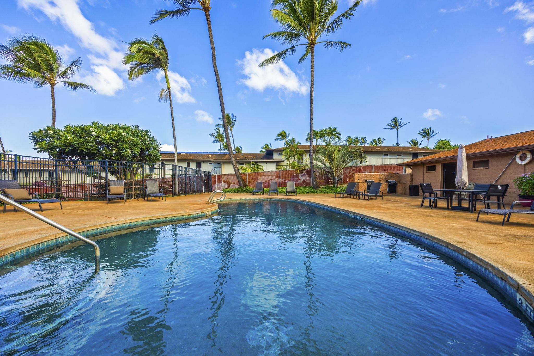 3740 Lower Honoapiilani Road, Unit F106 Lahaina, HI 96761 - Photo 19 of 28 a swimming pool with outdoor seating and yard