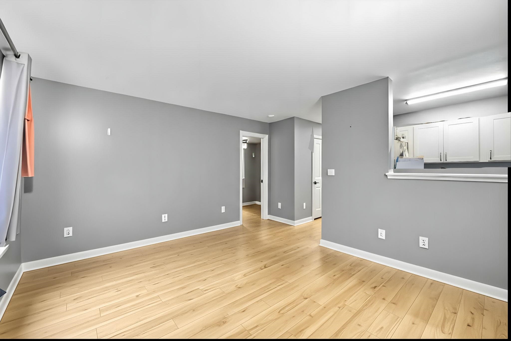 3740 Lower Honoapiilani Road, Unit F106 Lahaina, HI 96761 - Photo 4 of 28 a view of an empty room with wooden floor