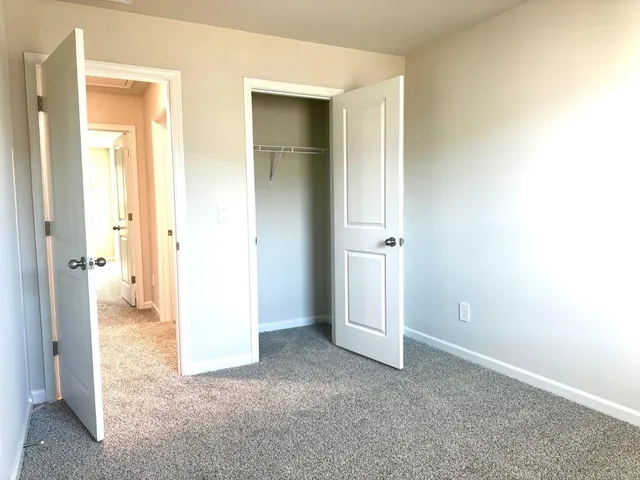 a bathroom with a sink a toilet a mirror and shower