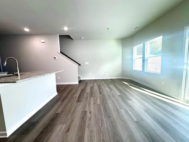 a view of a room with wooden floor and staircase