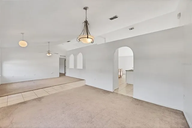 a view of a livingroom with a ceiling fan and window