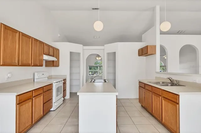 a kitchen that has a sink and a stove