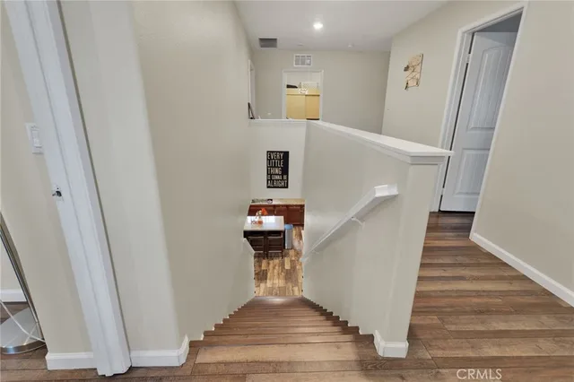 a view of entryway and hall with wooden floor