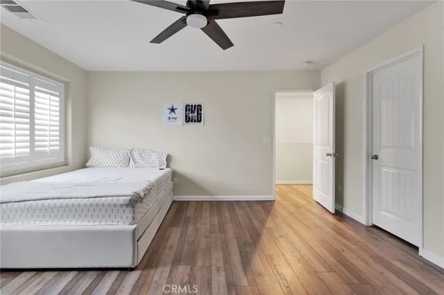 a room with a bed and wooden floor