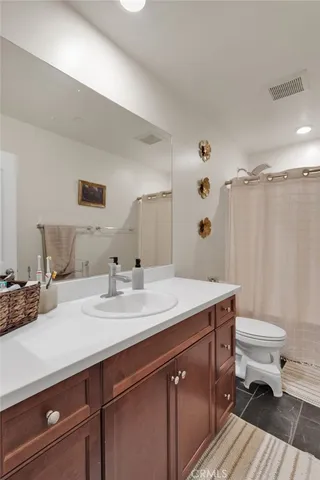 a view of bathroom with a sink toilet and a mirror