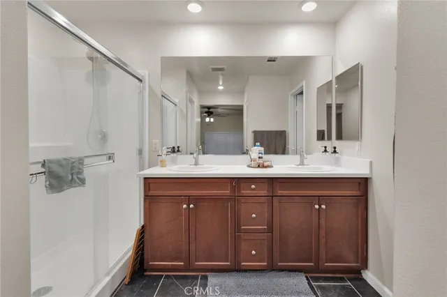 a bathroom with a double vanity sink a and a mirror