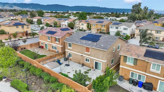an aerial view of multiple houses with a yard