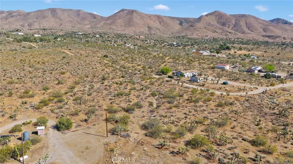 a view of a dry with mountains in the background
